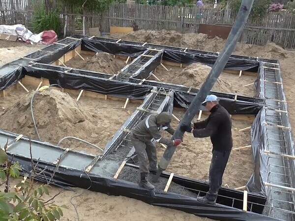 Заливка бетона при обустройстве фундамента при строительстве дома